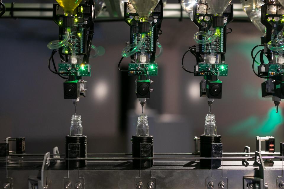 Perfume making machine putting fragrance into vials