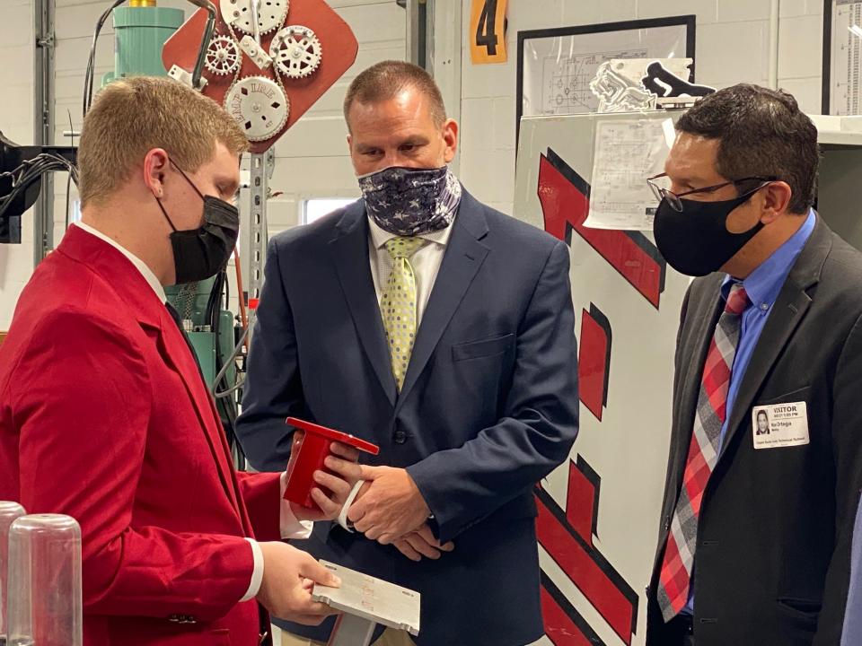 Upper Bucks Tech student Raymond Slifer speaks with executive director Jeff Sweda (center) and Pennsylvania Department of Education Acting Secretary Noe Ortega as he offers a tour of the campus facilities.