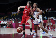 Japan's Moeko Nagaoka (0), left, and United States' A'Ja Wilson (9) fight for a rebound during women's basketball preliminary round game at the 2020 Summer Olympics, Friday, July 30, 2021, in Saitama, Japan. (AP Photo/Charlie Neibergall)