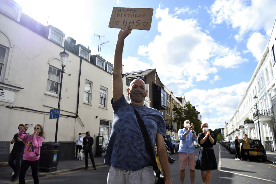 Locals join in the pause for applause to salute the NHS 72nd birthday,outside Chelsea and Westminster Hospital in London, Sunday, July 5, 2020. People across the U.K. joined a round of applause to celebrate the 72nd anniversary of the formation of the free-to-use National Health Service, undoubtedly the country’s most cherished institution. The reverence with which it is held has been accentuated this year during the coronavirus pandemic. (Kirsty O'Connor/PA via AP)