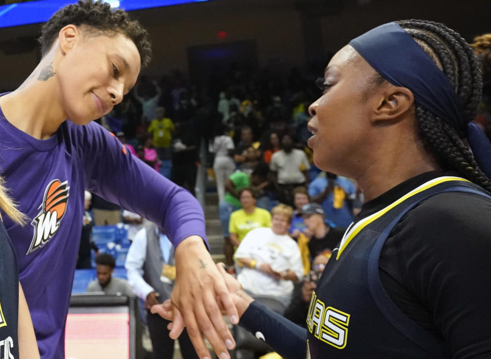 Phoenix Mercury center Brittney Griner, left, and former college teammate Dallas Wings guard Odyssey Sims greet each other after a WNBA basketball basketball game in Arlington, Texas, Friday, June 9, 2023. (AP Photo/LM Otero)