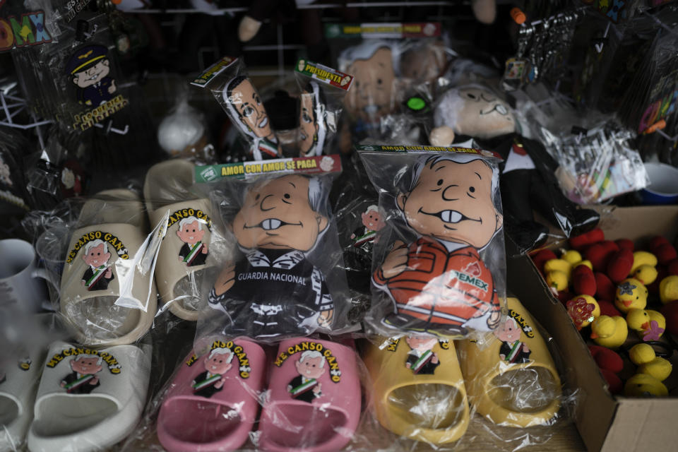 Dolls and sandals featuring Mexican President Andrés Manuel López Obrador are for sale outside the presidential palace in Mexico City, Friday, March 15, 2024. Despite not being eligible to run for reelection in the upcoming June 2 presidential vote, López Obrador looms larger than any of the candidates competing for the helm of Mexico’s government. (AP Photo/Eduardo Verdugo)