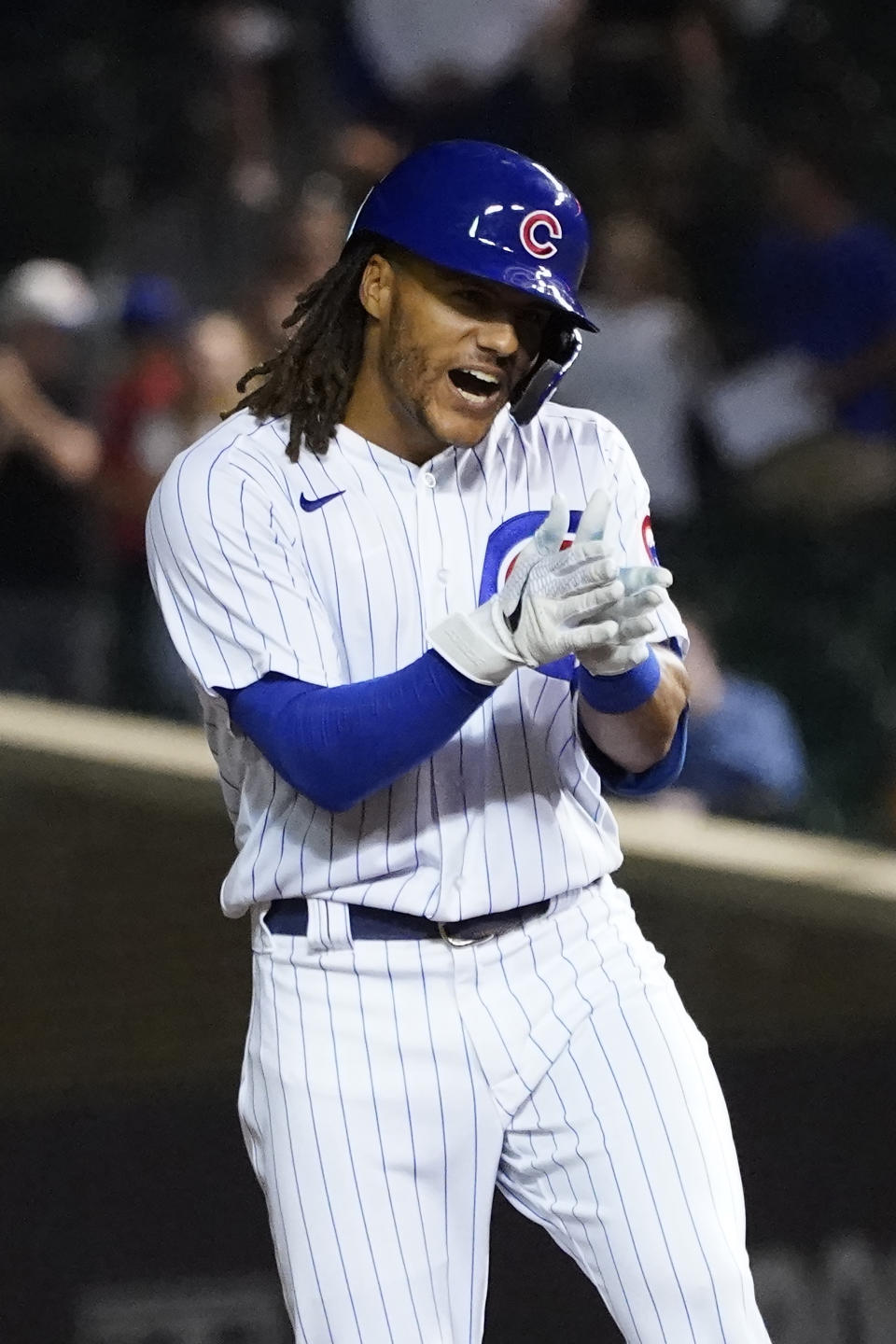 Chicago Cubs' Michael Hermosillo celebrates his RBI double off Colorado Rockies relief pitcher Carlos Estevez during the eighth inning of a baseball game Monday, Aug. 23, 2021, in Chicago. Ian Happ scored on the play. (AP Photo/Charles Rex Arbogast)