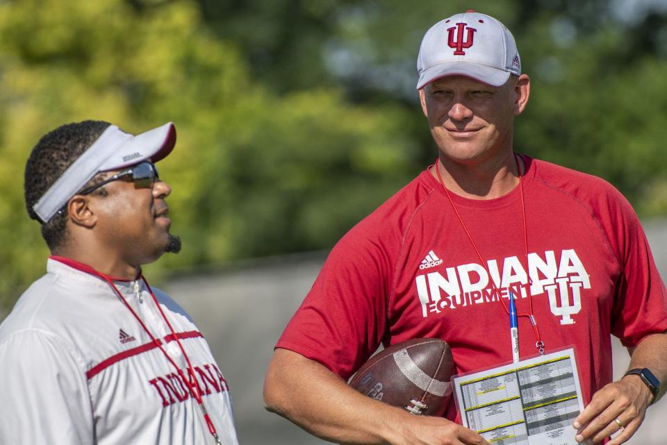 Indiana offensive coordinator Kalen DeBoer (right) talks with running backs coach Mike Hart during a practice on Aug. 7 at the practice fields outside Memorial Stadium. DeBoer is in his first year with the Hoosiers. (Rich Janzaruk / Herald-Times)