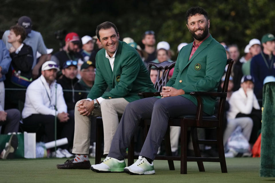 Scottie Scheffler sits with Jon Rahm, of Spain, after Rahm won the Masters golf tournament at Augusta National Golf Club on Sunday, April 9, 2023, in Augusta, Ga. (AP Photo/Jae C. Hong)