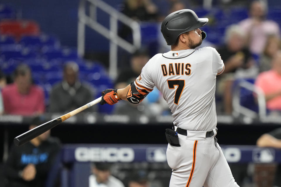 San Francisco Giants' J.D. Davis (7) follows through on a double during the fourth inning of a baseball game against the Miami Marlins, Tuesday, April 18, 2023, in Miami. (AP Photo/Lynne Sladky)