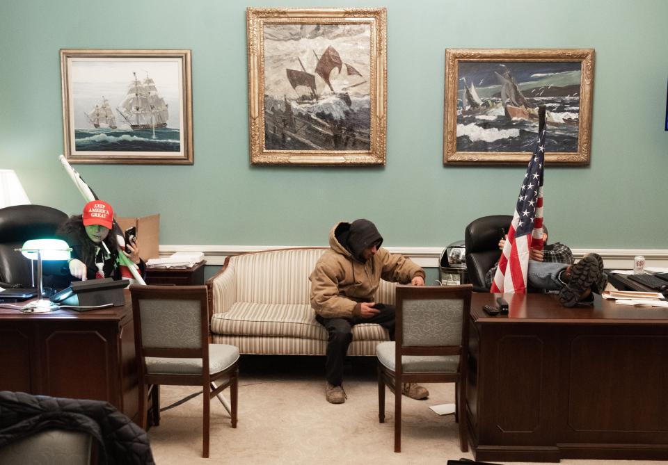 <p>Supporters of President Donald Trump sit inside the office of US Speaker of the House Nancy Pelosi.</p>AFP via Getty Images