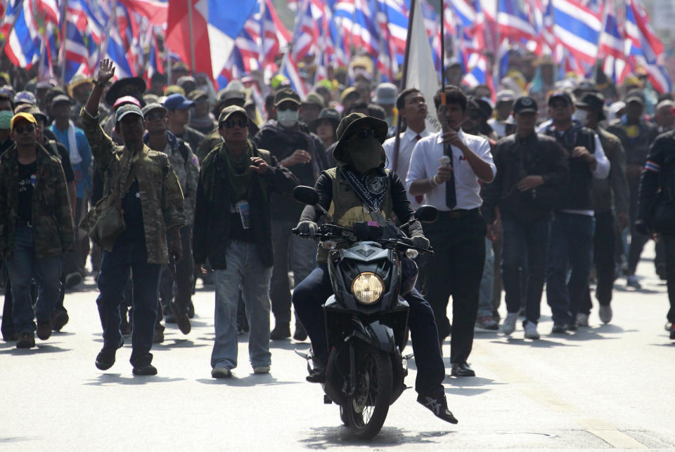 A motorcyclist leads a march of anti-government protesters during a rally Friday, Jan. 24, 2014 in Bangkok. Thailand’s Constitutional Court ruled Friday that nationwide elections scheduled for Feb. 2 can legally be delayed. (AP Photo/Wason Wanichakorn)