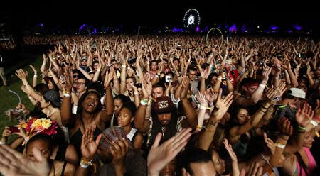 Concert-goers cheer during the performance of Canadian electrofunk duo Chromeo at the Coachella Valley Music and Arts Festival in Indio, California April 11, 2014. REUTERS/Mario Anzuoni