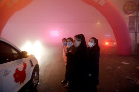 People make their way through heavy smog on an extremely polluted day with red alert issued, in Shengfang, Hebei province, China December 19, 2016. REUTERS/Damir Sagolj