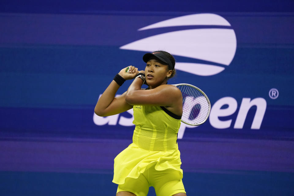 Naomi Osaka, of Japan, returns a shot to Leylah Fernandez, of Canada, during the third round of the US Open tennis championships, Friday, Sept. 3, 2021, in New York. (AP Photo/John Minchillo)