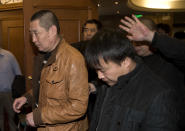 Chinese relatives of passengers aboard a missing Malaysia Airlines plane walk out from a hotel room after meeting with Malaysian officials, in Beijing, China Wednesday, March 12, 2014. The missing Malaysian jetliner may have attempted to turn back before it vanished from radar, but there is no evidence it reached the Strait of Malacca, Malaysia's air force chief said Wednesday, denying reported remarks he said otherwise. The statement suggested continued confusion over where the Boeing 777 might have ended up, more than four days after it disappeared en route to Beijing from Kuala Lumpur with 239 people on board. (AP Photo/Andy Wong)