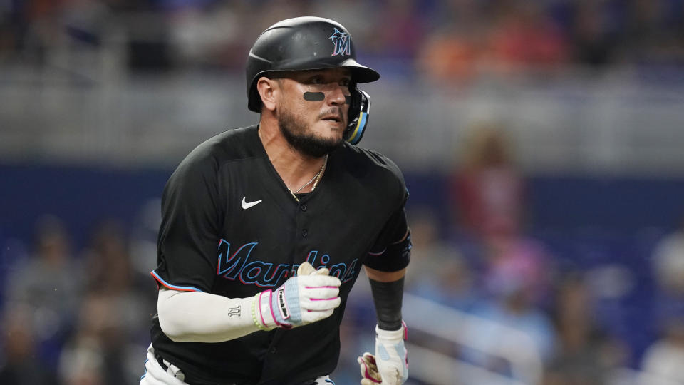 Miami Marlins' Miguel Rojas runs to first base after hitting a double during the second inning of the team's baseball game against the New York Mets, Friday, Sept. 9, 2022, in Miami. (AP Photo/Marta Lavandier)