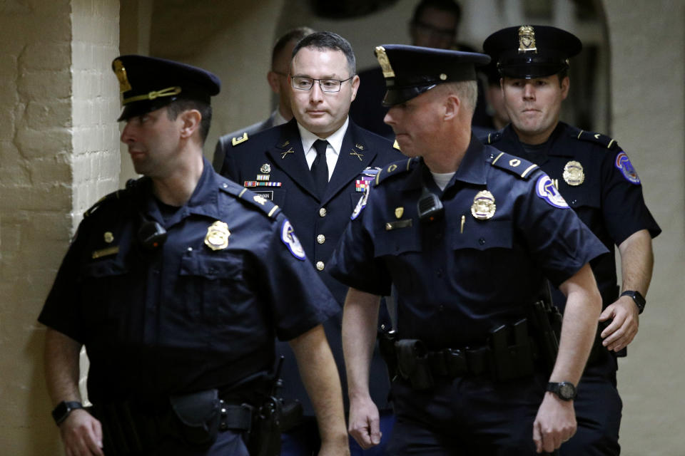 Army Lt. Col. Alexander Vindman, second from left, a military officer at the National Security Council, departs a closed door meeting after testifying as part of the House impeachment inquiry into President Donald Trump, Tuesday, Oct. 29, 2019, on Capitol Hill in Washington. (AP Photo/Patrick Semansky)