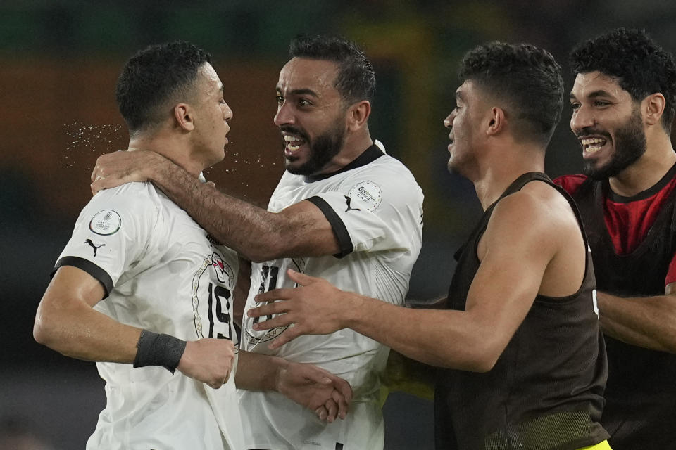 Egypt's Mostafa Mohamed, left, celebrates with Kahraba, 2nd left after scoring his side's second goal during the African Cup of Nations Group B soccer match between Cape Verde and Egypt at the Felix Houphouet Boigny stadium in Abidjan, Ivory Coast, Monday, Jan. 22, 2024. (AP Photo/Themba Hadebe)