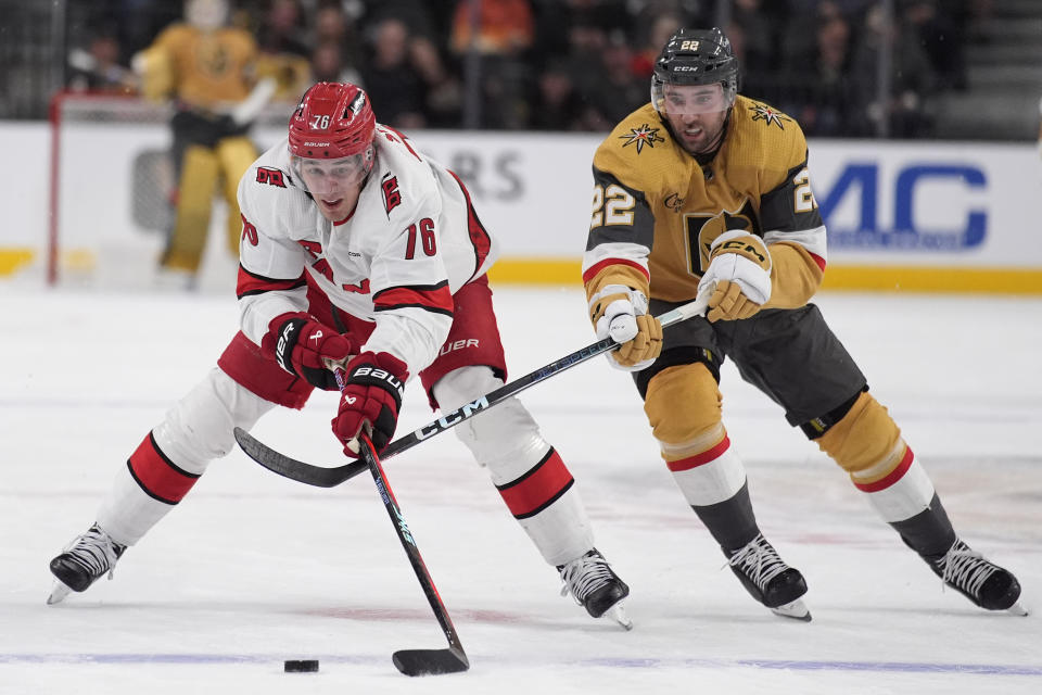 Carolina Hurricanes defenseman Brady Skjei (76) and Vegas Golden Knights' Michael Amadio battle for the puck during the second period of an NHL hockey game Saturday, Feb. 17, 2024, in Las Vegas. (AP Photo/John Locher)