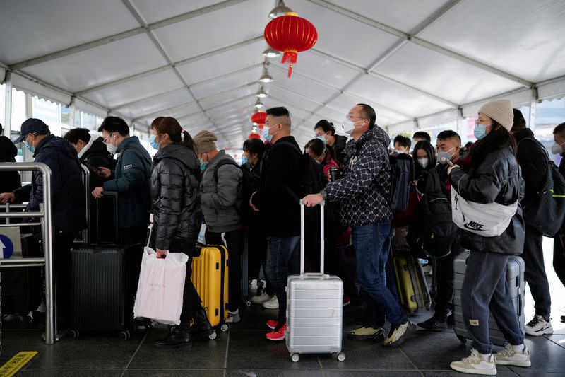 FILE PHOTO: People travel during annual Spring Festival travel rush, ahead of the Chinese Lunar New Year, in Shanghai