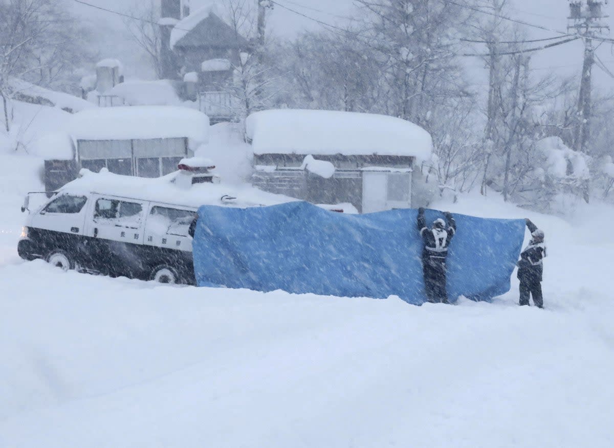 File - Rescue crews work to recover bodies after an avalanche  (via REUTERS)