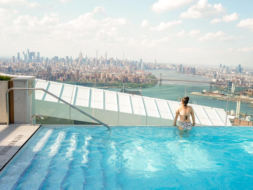 The author swims with the NYC skyline in the background.