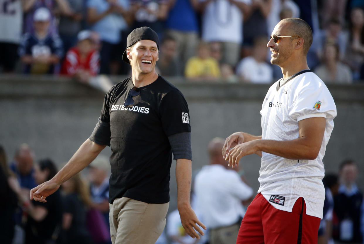 Former New England Patriots quarterback Tom Brady, left, walks with former teammate Christian Fauria during a charity football game in 2018. (AP Photo/Michael Dwyer, File)