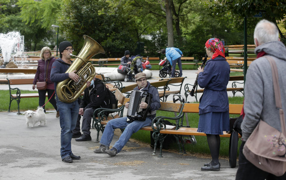 Musicians play music in a park in Vienna, Austria, Friday, May 1, 2020, after the Austrian government eased the movement of people. The Austrian government has moved to restrict freedom of movement for people, in an effort to slow the onset of the COVID-19 coronavirus. (AP Photo/Ronald Zak)