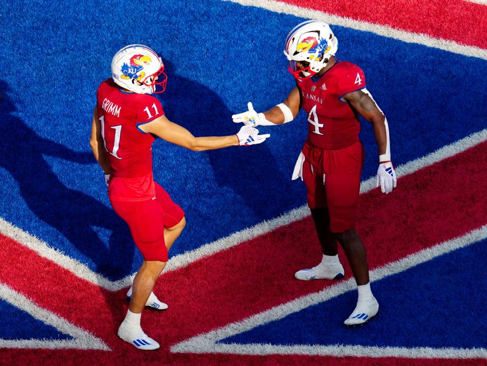 Kansas wide receiver Luke Grimm, left, celebrates his touchdown with Jayhawks running back Devin Neal during the Jayhawks' win over BYU last week. The Jayhawks are 4-0 and the No. 24 team in the country as they prepare to play No. 3 Texas in Austin on Saturday.