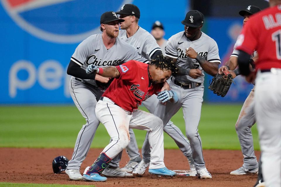 Chicago White Sox's Michael Kopech, left, holds Cleveland Guardians' Jose Ramírez, center, as White Sox's Tim Anderson throws a punch during the sixth inning of a baseball game Saturday, Aug. 5, 2023, in Cleveland. Anderson and Ramírez were among those ejected. (AP Photo/Sue Ogrocki)