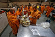 Members of Bochasanwasi Akshar Purushottam Sanstha (BAPS) pack vegetables inside a community kitchen to be distributed amongst poor people during a 21-day nationwide lockdown to limit the spreading of Coronavirus disease (COVID-19), in Ahmedabad, India, March 27, 2020. REUTERS/Amit Dave