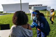 FILE - In this May 6, 2021, file photo, Kendria Brown, a nurse with DC health, vaccinates a woman with the Johnson & Johnson COVID-19 vaccine at The REACH at the Kennedy Center in Washington. From South Carolina to Washington, states are requesting the Biden administration send them only a fraction of what's been allocated to them. The turned-down vaccines amount to hundreds of thousands of doses this week alone, providing a stark illustration of the problem of vaccine hesitancy in the U.S. (AP Photo/Jacquelyn Martin, File)