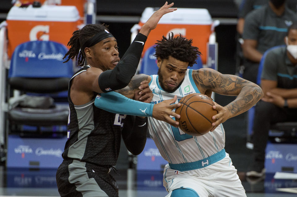 Sacramento Kings guard Buddy Hield (24) defends against Charlotte Hornets forward Miles Bridges (0) during the first quarter of an NBA basketball game in Sacramento, Calif., Sunday, Feb. 28, 2021. (AP Photo/Randall Benton)