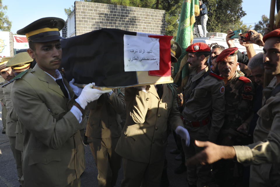 Syrian student officers carry the coffin of Major Mohammed Akkari who was killed on Thursday in a drone attack that hit a military graduation ceremony, during a mass funeral procession in Homs, Syria, Friday, Oct. 6, 2023. Family members of some of the victims of deadly drone attacks on a crowded military graduation that killed scores gathered outside a military hospital in this central city Friday to collect the bodies of their loved ones who lost their lives in one of Syria's deadliest single attacks in years. (AP Photo/Abdelrahman Shaheen)