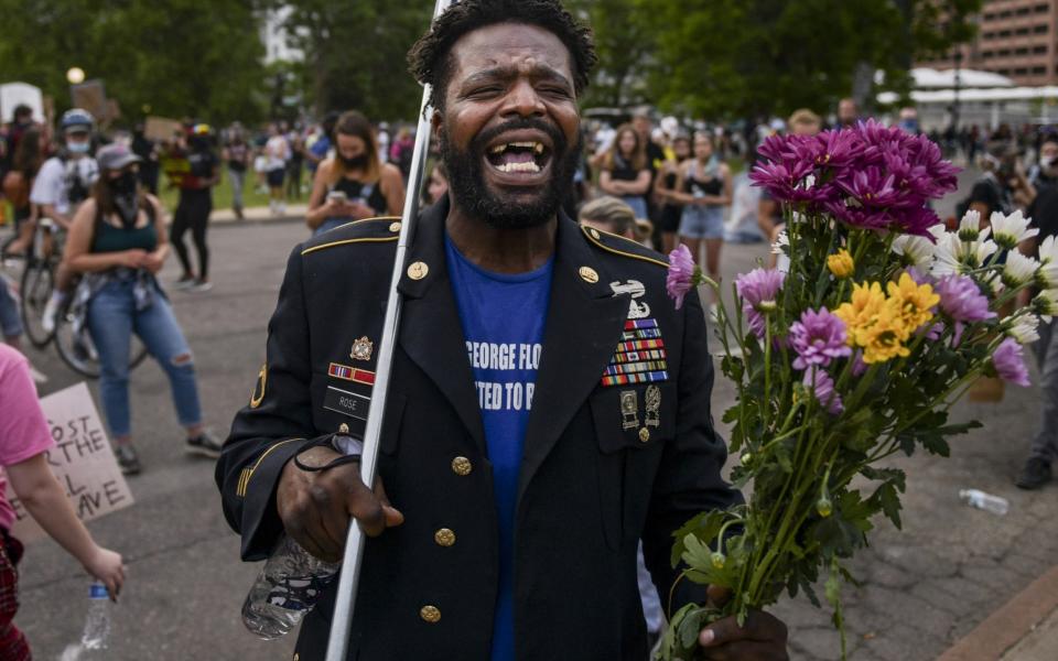 Retired Army Staff Sgt. Aubrey Rose starts a chant at a protest on June 1 in Denver - Michael Ciaglo 