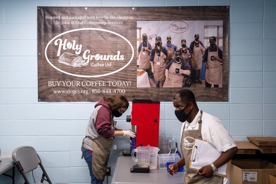 Krystal Hagerthey, left, grinds coffee beans for Holy Grounds at St John of God Community Services Thursday, July 14, 2022 in Westville, NJ.