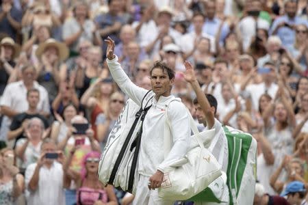 Jul 14, 2018; London, United Kingdom; Rafael Nadal (ESP) leaves the court after his match against Novak Djokovic (SRB) on day 12 at All England Lawn and Croquet Club. Mandatory Credit: Susan Mullane-USA TODAY Sports