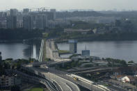 A bus carrying passengers crosses the The Johor - Singapore Causeway in Johor Bahru, Malaysia, Monday, Nov. 29, 2021. Malaysia and Singapore reopened their borders for fully vaccinated citizens and some others, after nearly two years of closure due to the pandemic that had stranded many Malaysians working in the neighboring city-state away from their families. (AP Photo/Vincent Thian)