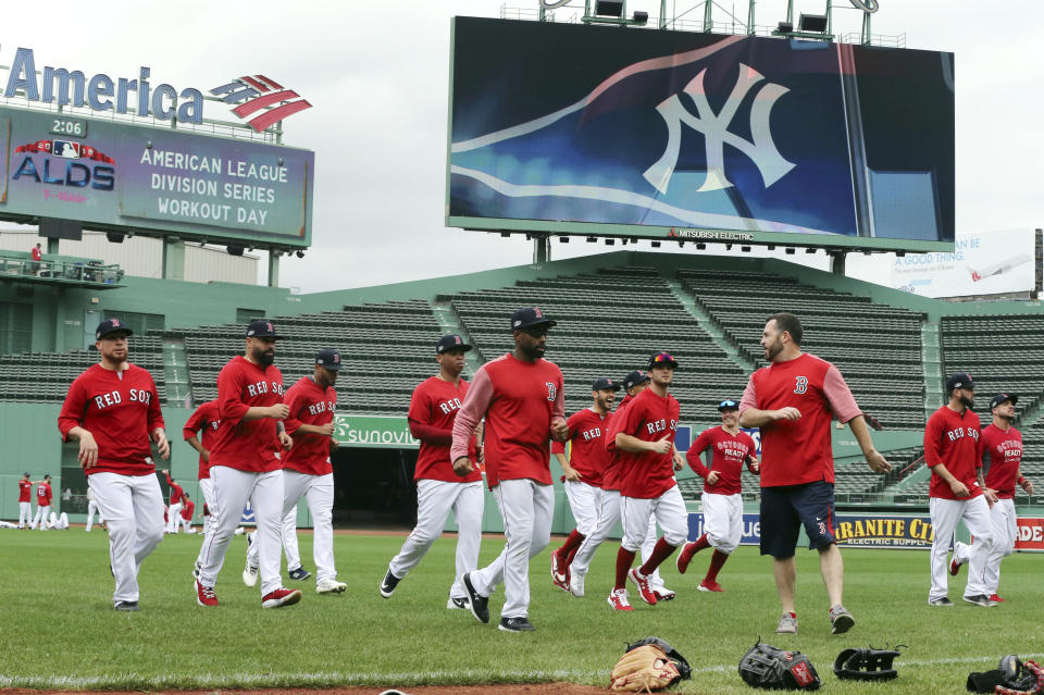 Boston Red Sox players warm up during a baseball workout at Fenway Park, Thursday, Oct. 4, 2018, in Boston, in preparation for Game 1 of the ALDS against the New York Yankees on Friday. (AP Photo/Elise Amendola)