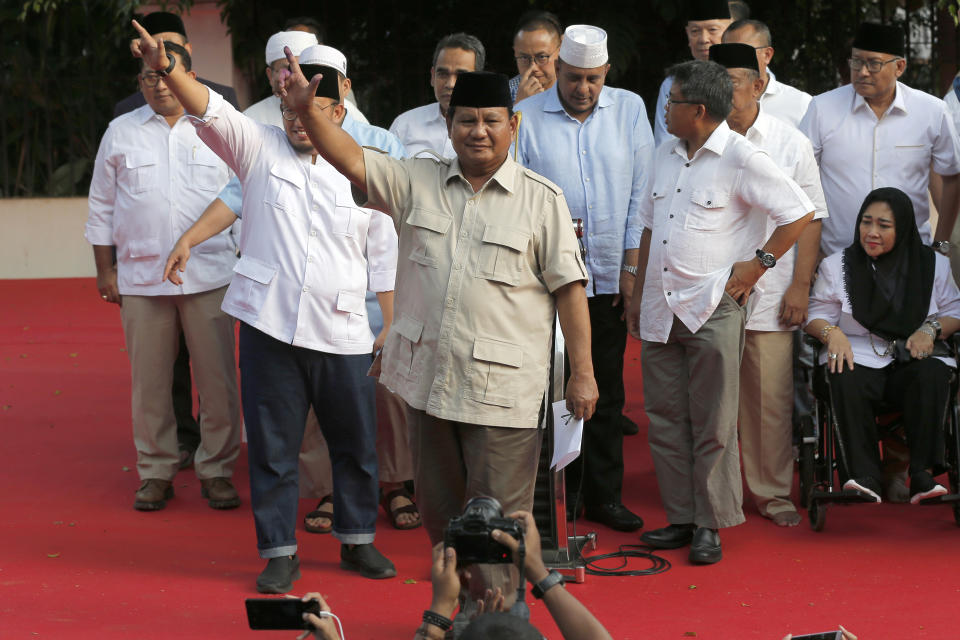 Indonesian presidential candidate Prabowo Subianto, center, gestures during a press conference in Jakarta, Indonesia, Wednesday, April 17, 2019. Indonesian President Joko Widodo is on track to win a second term, preliminary election results showed Wednesday, in apparent victory for moderation over the ultra-nationalistic rhetoric of his rival Subianto.(AP Photo/Tatan Syuflana)