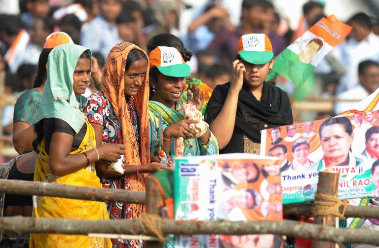 Indian supporters of the Congress Party President and Chairperson of India's United Progressive Alliance, Sonia Gandhi, hold banners during an election rally in Karimnagar on April 16, 2014