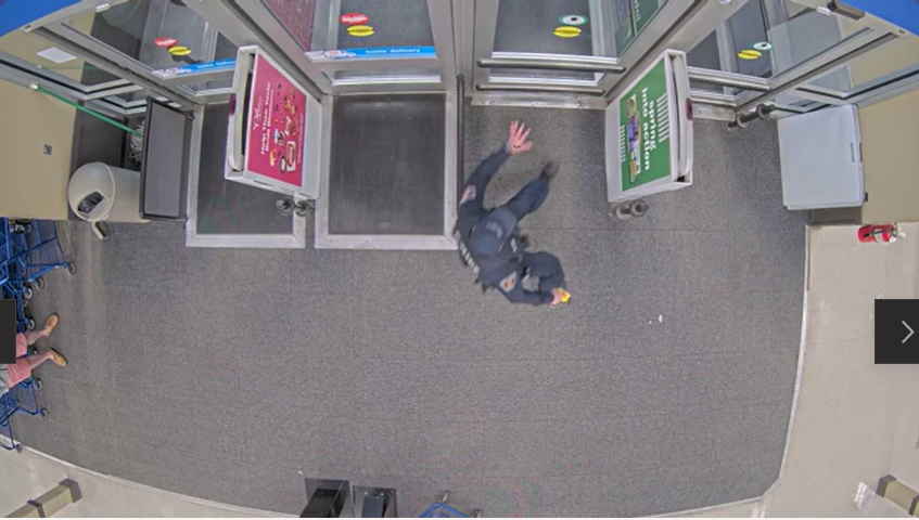 An East Lansing police officer runs with a stun gun while chasing a 20-year-old out of Meijer at 1350 W. Lake Lansing Road in East Lansing on April 25, 2022.