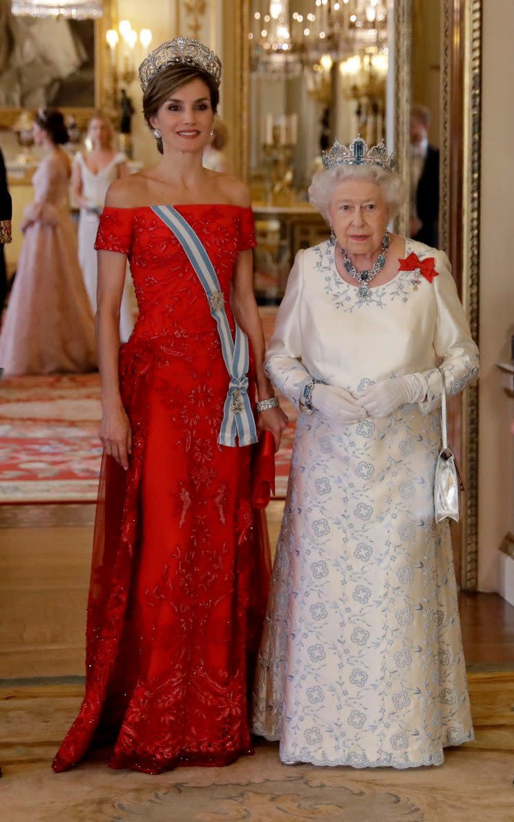 Spanish royal Queen Letizia donned a red gown to meet the Queen [Photo: AFP]