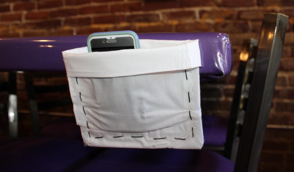 A diner utilizes a phone pocket at Table of Love, a Southern soul food restaurant, in Hopewell, Va.