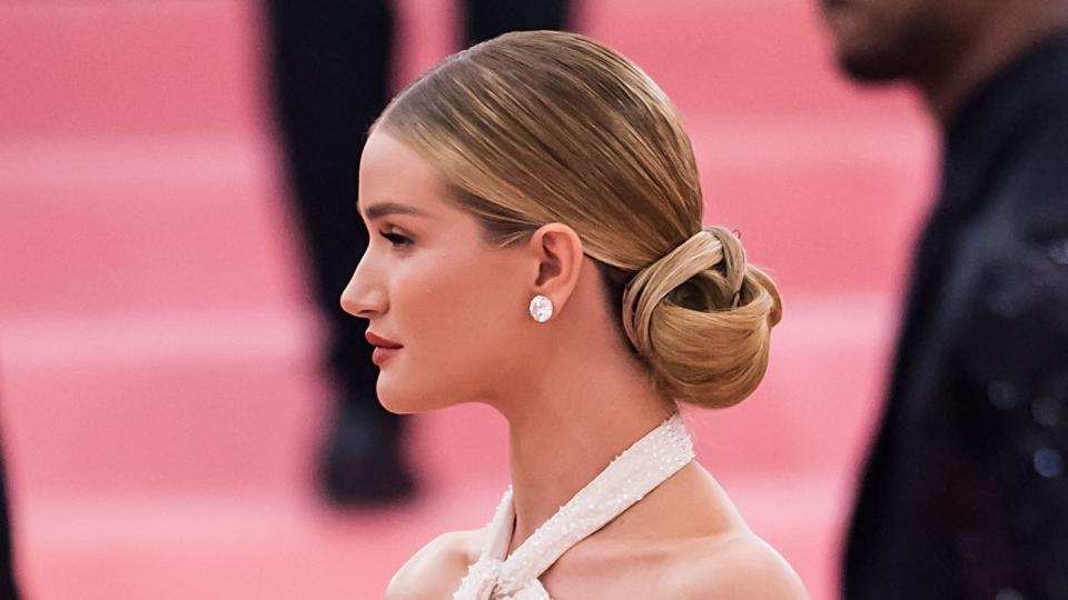 <p> If you haven’t seen the incredible feathered cape (complete with train) that Rosie Huntington-Whitely wore to the 2019 Gala, you’ll want to remedy that pretty quickly. An outfit that bold required low-key hair in the form of this ballerina bun to avoid a clash. </p>