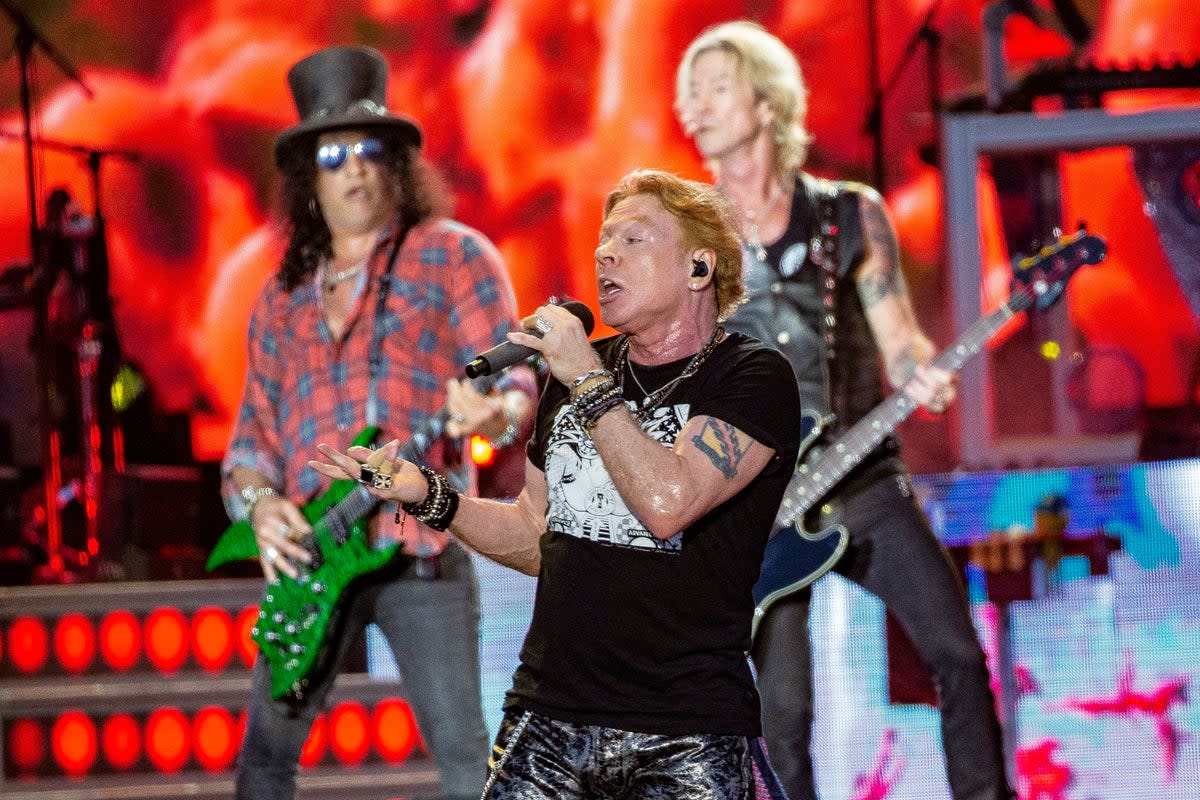Axl Rose, center, Slash, back left and Duff McKagan, (Joel C Ryan/Invision/AP)