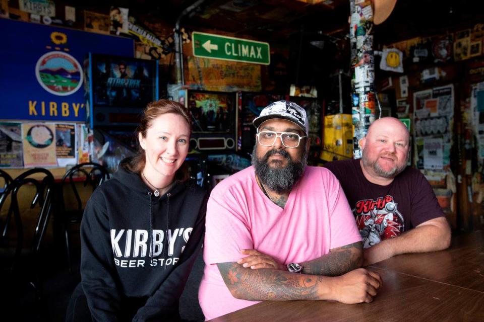 Tanisha Bell, left, and Ryan Bell, right are pictured with Kirby’s majority owner Alex Thomas in 2022, when the bar turned 50.