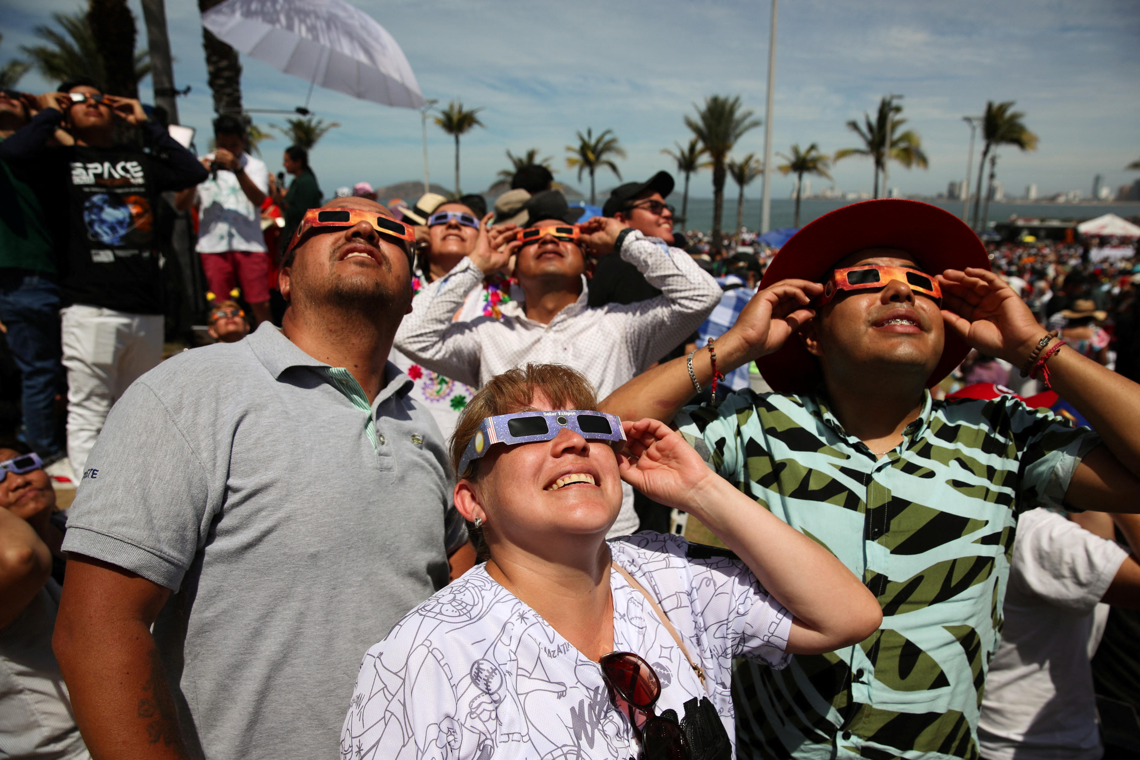 People use special protective glasses to observe a total solar eclipse in Mazatlan, Mexico April 8, 2024. (Henry Romero/Reuters)