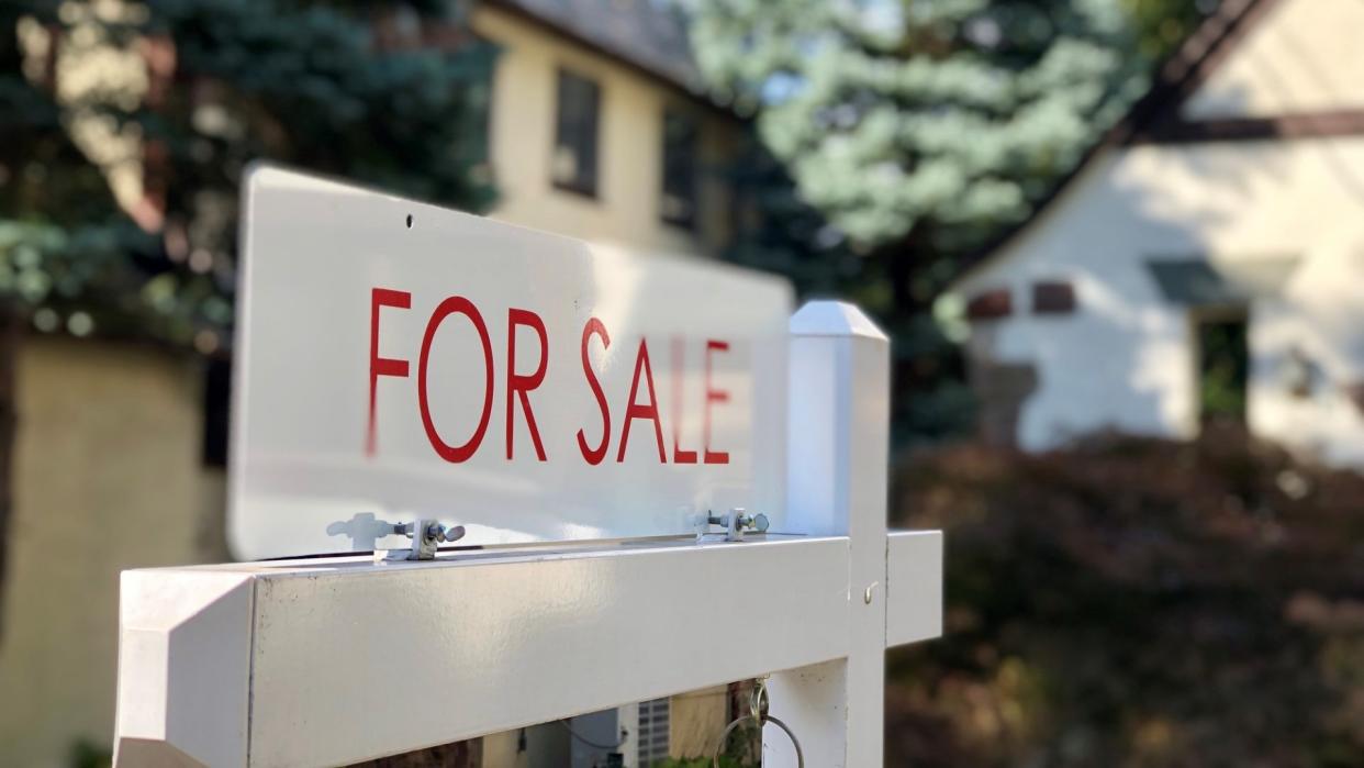 Real estate for sale sign in residential neighborhood, New Jersey, USA.