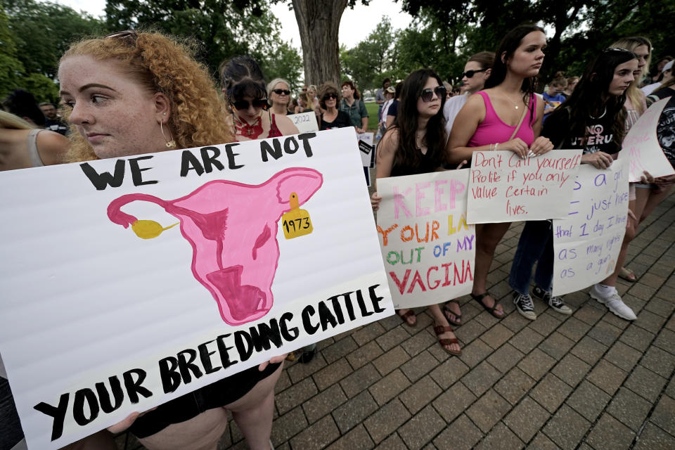 FILE - Abortion-rights advocates gather outside a the Kansas Statehouse to protest the U.S. Supreme Court's ruling on abortion, June 24, 2022, in Topeka, Kan. The Republican-controlled Kansas Legislature is considering millions of dollars in state funds for centers that provide pregnancy tests, sonograms and counseling in an effort to keep women from having abortions. Also on the table: millions more in income tax credits to their donors. (AP Photo/Charlie Riedel, File)