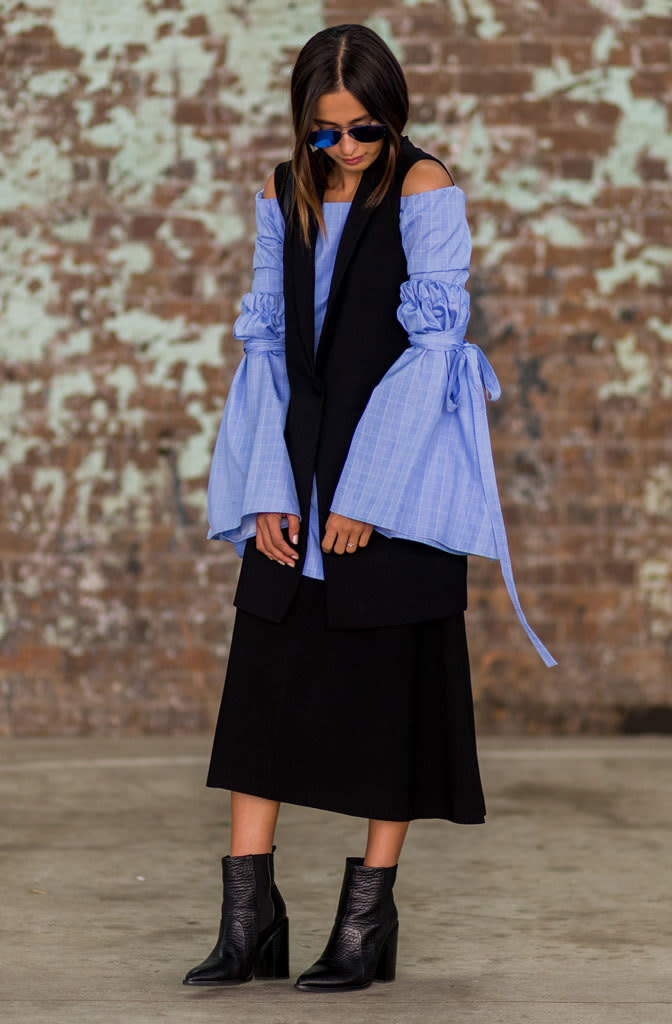 Eleanor Pendleton from the online mag Gritty Pretty sporting an avant-garde bell-sleeve blouse underneath a V-neck dress in Sydney, Australia.