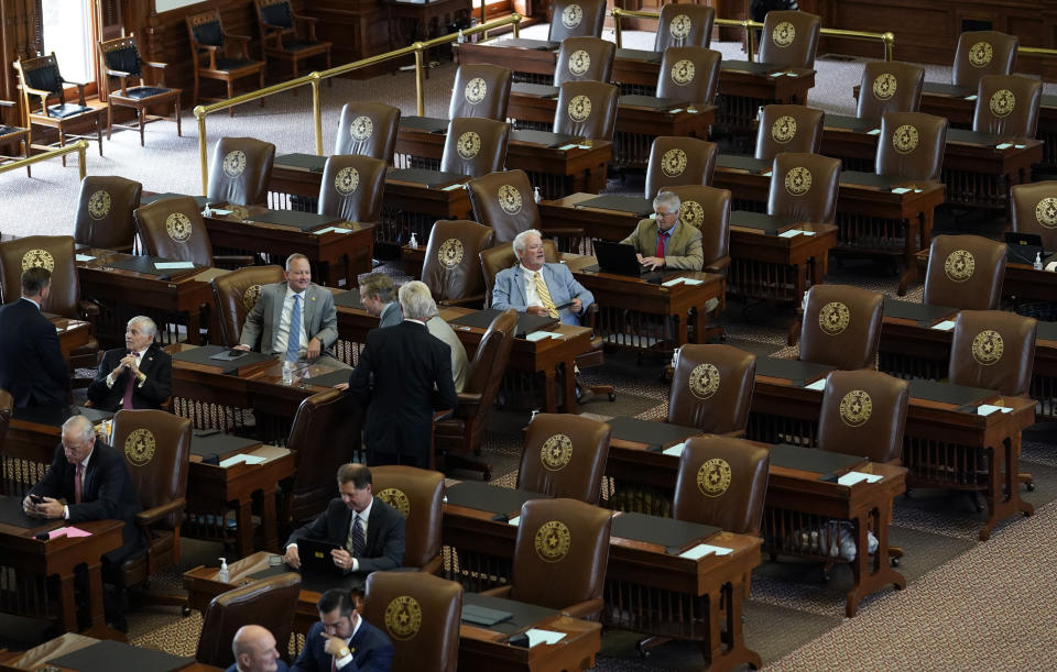 FILE - In this July 13, 2021, file photo empty seats are seen in the House Chamber at the Texas Capitol in Austin, Texas. Texas Democrats left the state to block sweeping new election laws, while Republican Gov. Greg Abbott threatened them with arrest the moment they return. (AP Photo/Eric Gay, File)