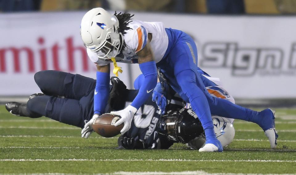 Boise State safety Rodney Robinson, top, recovers the ball after Utah State running back Robert Briggs Jr. (2) fumbled in the first half of an NCAA college football game Saturday, Nov. 18, 2023, in Logan, Utah. | Eli Lucero/The Herald Journal via AP